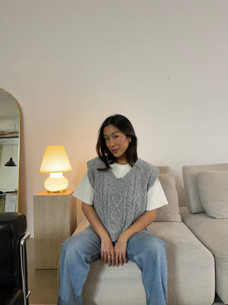 a woman sitting on a couch in a living room