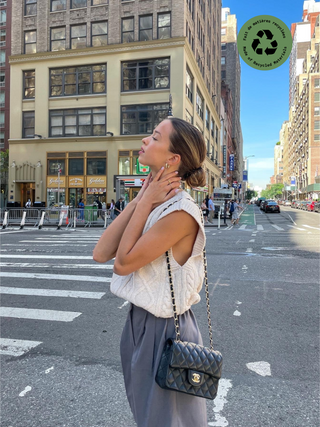 a woman standing in the middle of a city street