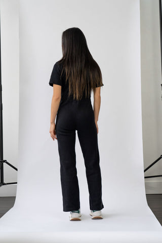 a woman standing in front of a white backdrop