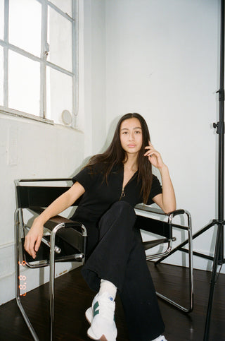 a woman sitting on a chair in a room