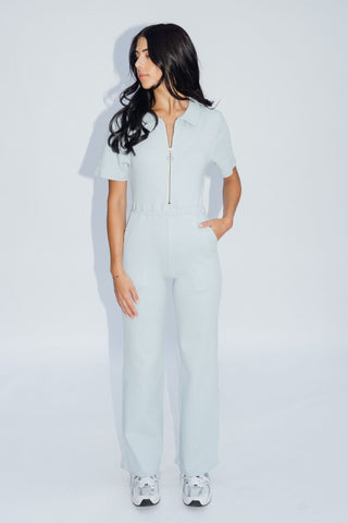 a woman wearing a light blue jumpsuit