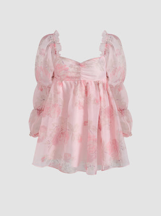 a baby girl ' s pink dress with floral print