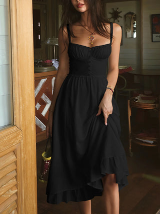 a woman in a black dress standing in a doorway