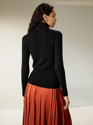 a woman in an orange skirt and black sweater