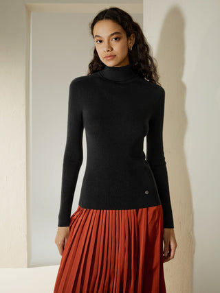 a woman in a black turtle neck sweater and red plea skirt