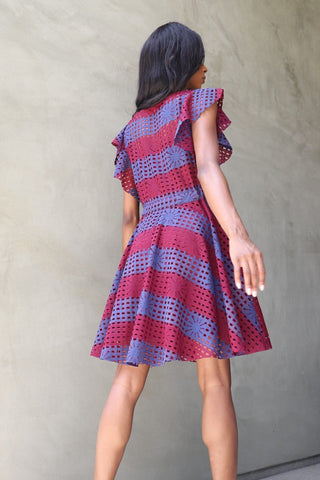 a little girl in a red and blue dress