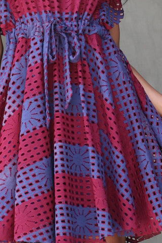 a woman wearing a red and blue dress