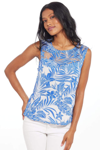 a woman wearing a blue and white floral print top