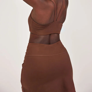 the back of a woman wearing a brown dress