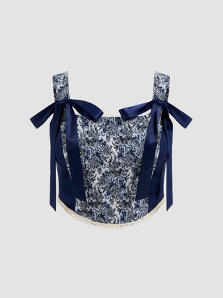 a crop top with a floral print and a navy bow