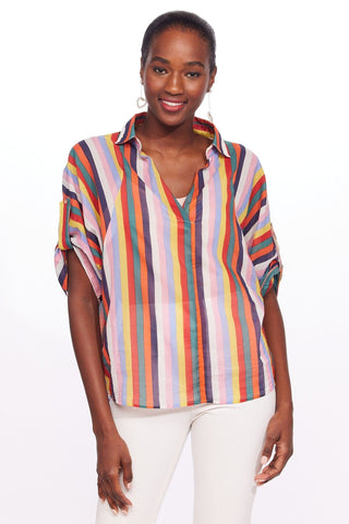 a woman wearing a colorful striped shirt