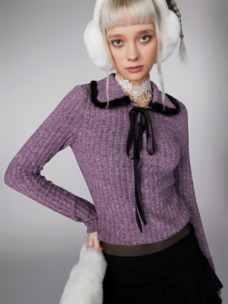 a woman wearing headphones and a purple sweater