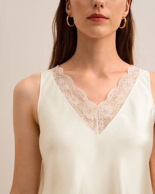 a woman wearing a white top with lace on it