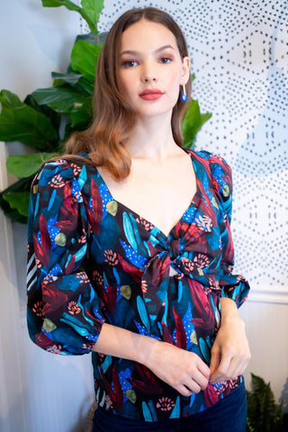 a woman standing in front of a plant