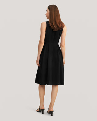 the back view of a woman in a black dress