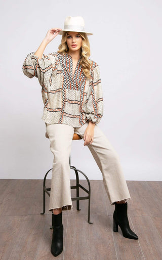 a woman sitting on a chair wearing a white hat