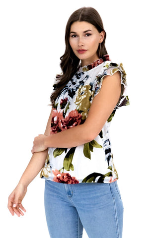 a woman in jeans and a floral top