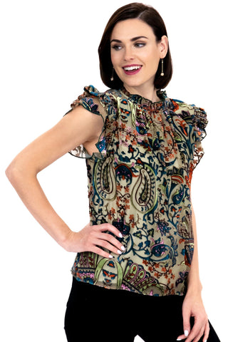 a woman wearing a top with a floral pattern