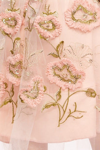 a pink and gold dress with flowers on it