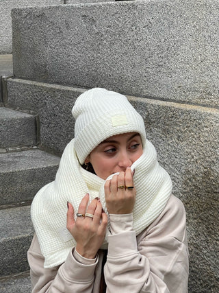 a woman wearing a white hat and scarf