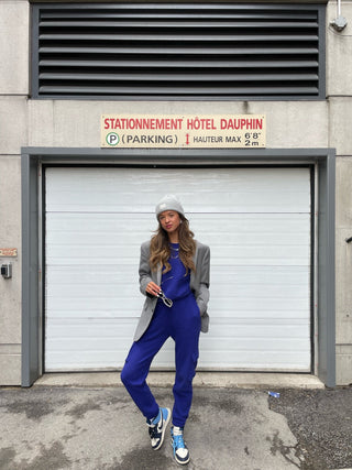 a woman standing in front of a garage door