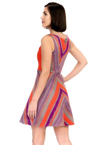 a woman in a purple and orange dress