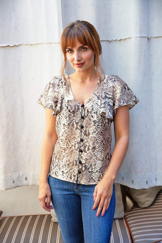 a woman standing in front of a white wall