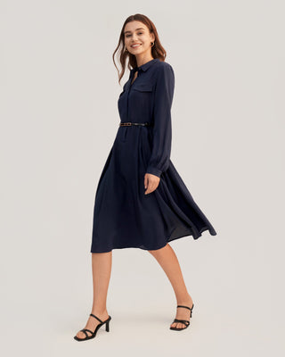 a woman wearing a navy shirt dress and black heels