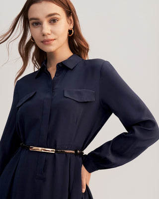 a woman wearing a navy shirt dress with a belt