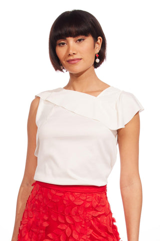 a woman in a white top and red skirt