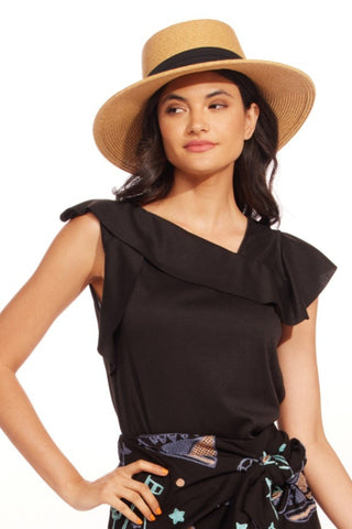 a woman wearing a straw hat and a black top