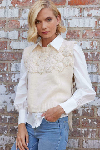 a woman standing in front of a brick wall